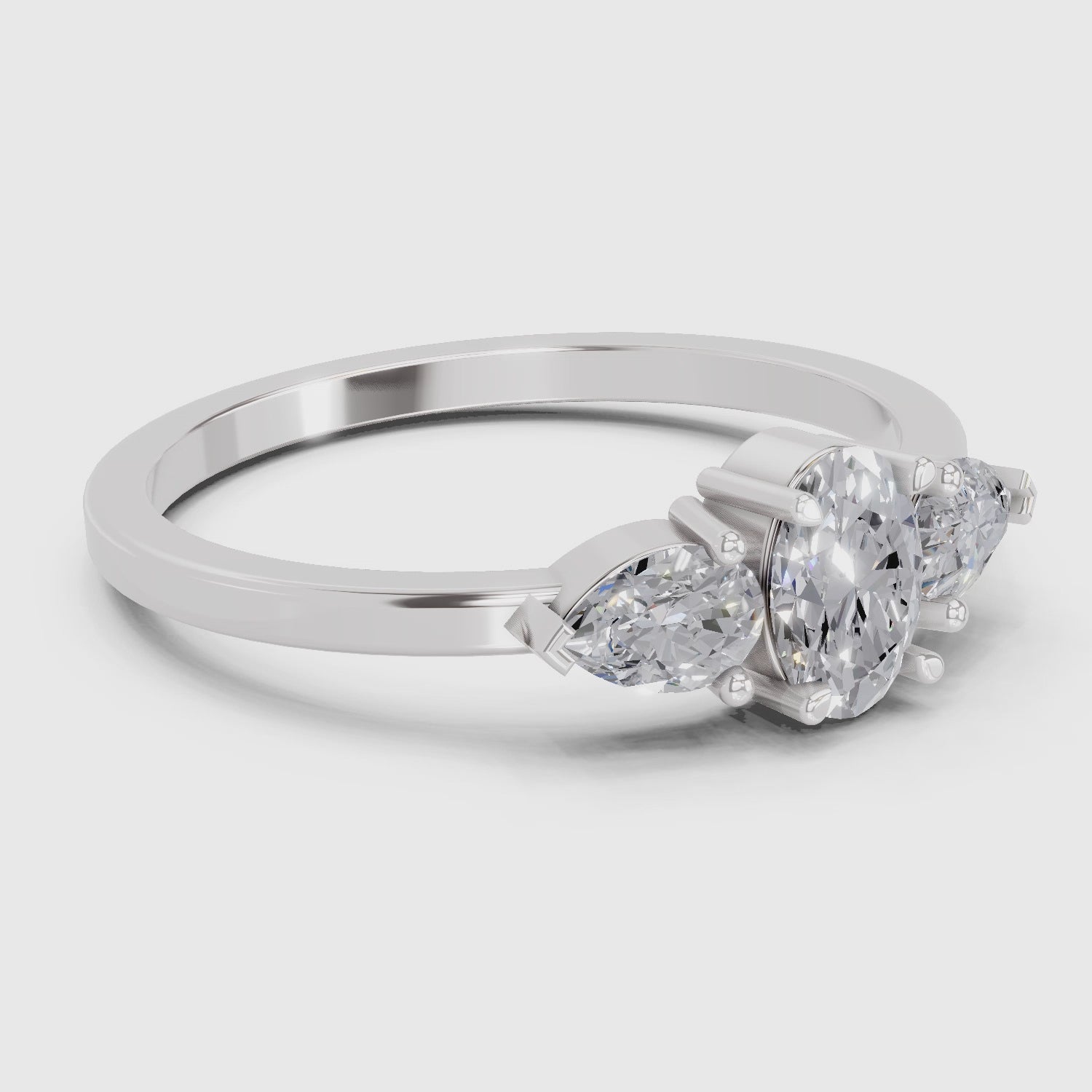 Load video: 0.60 Carat Three-Stone Oval &amp; Pear Diamond Engagement Ring | 14K White Gold