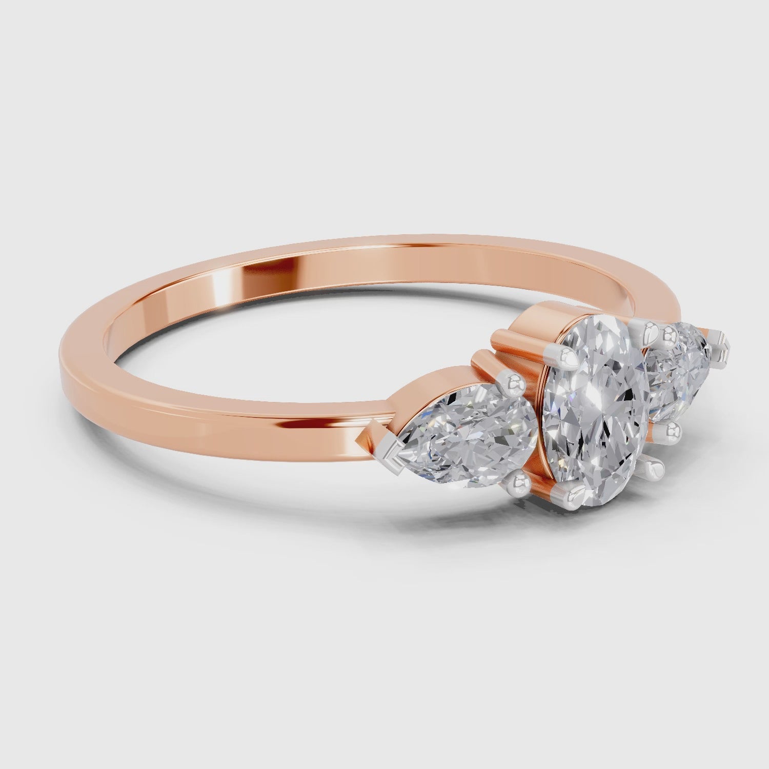 Load video: 0.60 Carat Three-Stone Oval &amp; Pear Diamond Engagement Ring | 14K Rose Gold